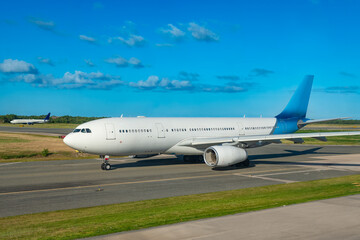 An Airbus A330 is taxiing on the runway at Punta Cana Airport. The aircraft is preparing for...
