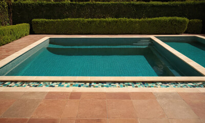 A backyard pool with a tiled floor, perfect for summer relaxation