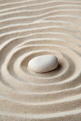 Obraz premium Tranquil zen garden with smooth stone on raked sand patterns