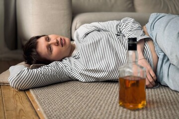 woman suffers from alcoholism and problems of loneliness at home
