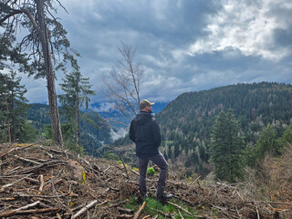 A contemplative man is peacefully overlooking a breathtaking, scenic mountain landscape Meran Bozen...