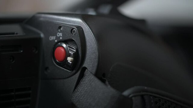 4K extreme macro footage of pressing red record button on camcorder
