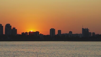 Experience the stunning beauty of a sunset reflecting over a vibrant urban skyline. Media