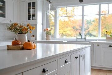 white kitchen island with fall decor and autumn view