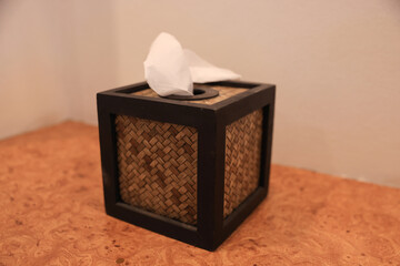 A woven tissue  box  and vase with flower handmake in the hotel  room
