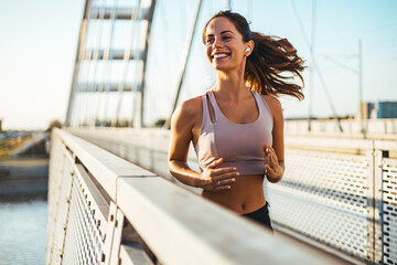 Happy Woman Jogging on a Bridge During a Morning Workout