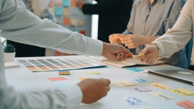 A vibrant and dynamic scene showcasing a group engaged in a brainstorming session with colorful sticky notes, emphasizing collaboration and innovative thinking in a modern office environment. SACTR