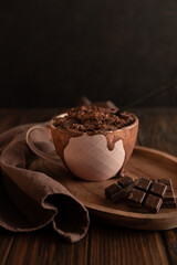 Chocolate mug cake on dark wooden table.Easy homemade dessert. Mugcake from microwave