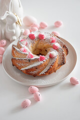 Traditional Easter cakes with icing decorated candies on white wooden table