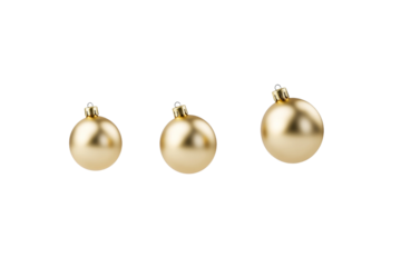 Three gold ornaments are suspended in the air, isolated