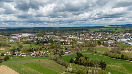 Obraz premium View of a city embedded in green forests and meadows