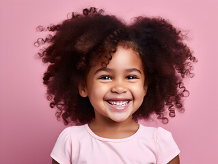 Portrait of a beautiful young Afroamerican girl smiling, pink background  