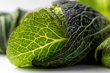 Fototapeta premium A close-up of savoy cabbage showing the intricate details of the leaf, veins, and textures, revealing the beauty and complexity of nature's designs in food.