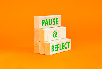 Pause and reflect symbol. Concept words Pause and reflect on beautiful block. Beautiful orange...