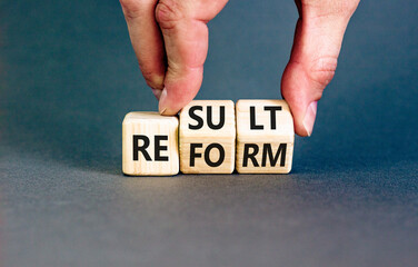 Reform and result symbol. Concept words Reform Result on beautiful wooden block. Beautiful grey...