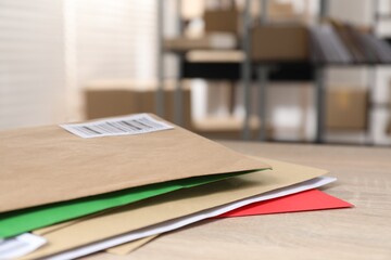 Many different envelopes on table in post office. Space for text