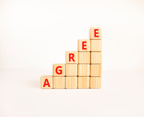 Agree symbol. Concept word Agree on beautiful wooden blocks. Beautiful white table white...