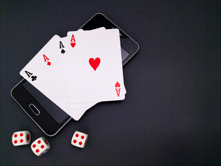 playing cards and dice on a black table