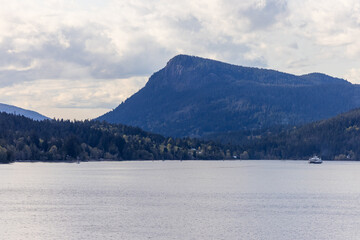 Serene Mountain Scenery by a Tranquil Canadian Lake with Distant Boat