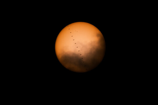 Transit of the International Space Station across the sun. ISS solar transit between the clouds