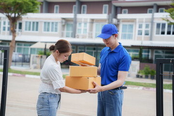 Happy woman, delivery man and box at door for customer's order, parcel or goods in delivery service. Woman receiving goods from male delivery man, delivered to home.