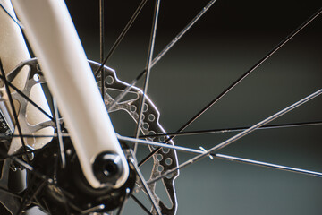 close view of spokes and disc brake rotor on a bike, engineering detail of a bicycle front wheel