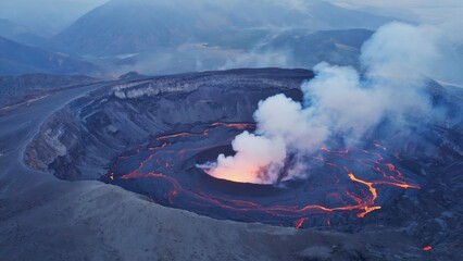 Majestic crater of an active volcano with visible lava flowing down its sides.