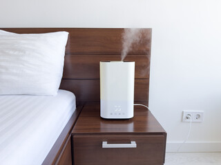 Humidifier on bedside table in modern bedroom enhancing air quality during daytime