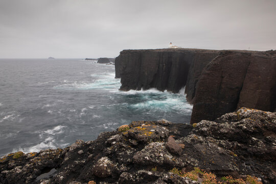 Dramatic landscape photograph of the cliffs of Eshaness on a gloomy and windy day.