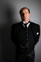 Butler or Hotel Concierge in Black Formal Suit Standing at Attention. Professional Hospitality and Courteous Service