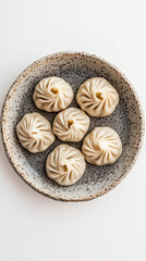 Fototapeta premium Traditional khinkali dumplings on rustic ceramic plate, top view.