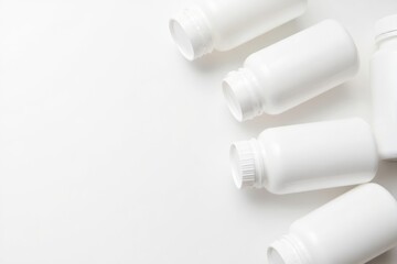 White medicine bottles on white surface

