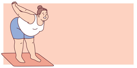Curvy woman in active wear performs forward bend on mat. Body positive yoga routine showing flexibility, movement and self love. Additional space for text