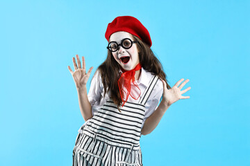 Emotional girl dressed like mime on light blue background. Surprise party