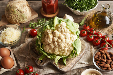 Fresh cauliflower, tomatoes, eggs, cheese and almond meal - Ingredients for homemade gluten-free pizza