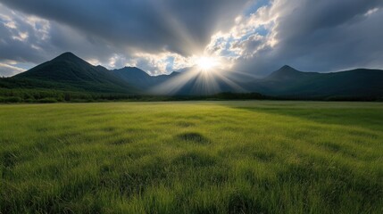 Fototapeta premium Vast field, sunbeams, mountains