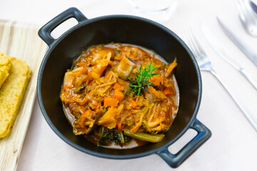 Cassoula with polenta. Meat on the bone with stewed vegetables