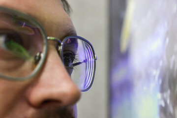 Man wearing stylish glasses on blurred background, closeup