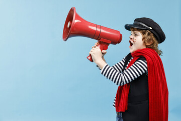 Cute boy in mime costume shouting in megaphone on light blue background, space for text. Surprise...