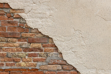 Exposed Brick Wall with Crumbling Plaster