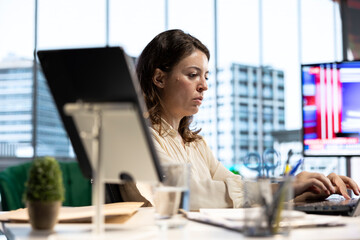 Empowered ambitious female CEO working on career development strategy, multitasking in order to...