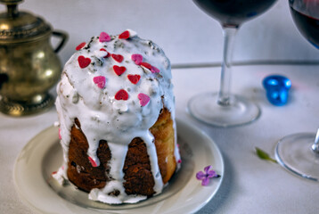 Traditional Easter cakes on festive table decorated with fresh flowers and colorful painted Easter eggs. Kulich is kind of Easter bread that is traditional in the Orthodox Christian faith