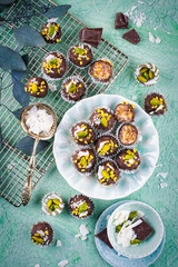 Artisan homemade fine dark chocolate pralines with pistachio and coconut chips