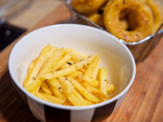 Crispy Seasoned French Fries Served with Onion Rings