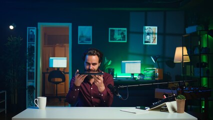 Tech content creator filming review of newly released gaming laptop, unboxing it and giving...