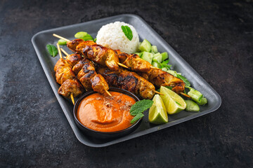 Sate Ayam- grilled chicken satay sate skewers with peanut dipping spicy sauce, steamed rice and...