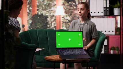 Therapist uses green screen display in a counseling session with an adolescent dealing with low confidence. Psychotherapist supports her in building resilience and self esteem. Camera A.