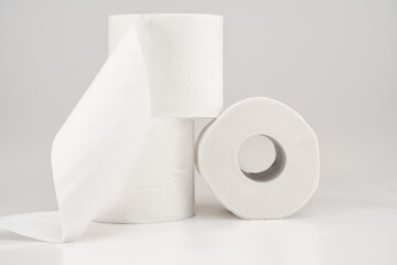 Composition of White Toilet Paper Rolls on Light Background
