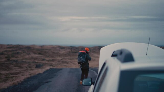 Man Experiencing Car Breakdown in Remote Icelandic Landscape