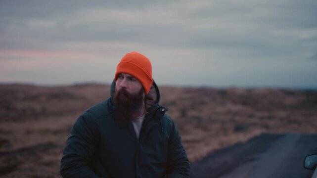 Man Experiencing Car Breakdown in Remote Icelandic Landscape
